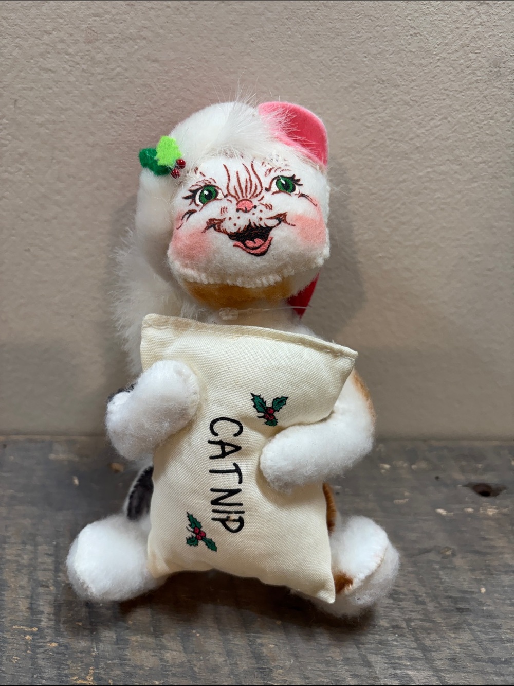 Annalee Cat holding catnip White Plush White Holiday cat wearing Santa hat.